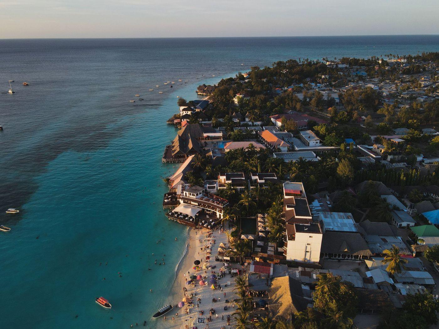 A resort beach curving away below a low headland